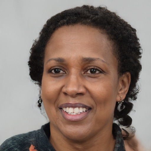 Joyful black adult female with short  brown hair and brown eyes