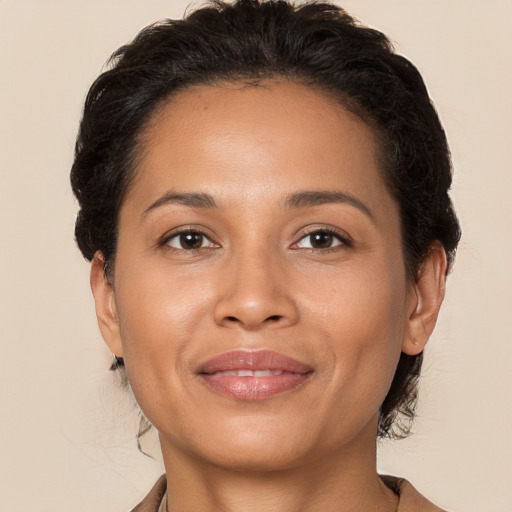 Joyful latino adult female with medium  brown hair and brown eyes