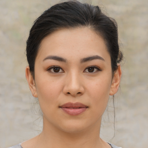Joyful asian young-adult female with medium  brown hair and brown eyes