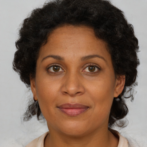 Joyful black adult female with medium  brown hair and brown eyes