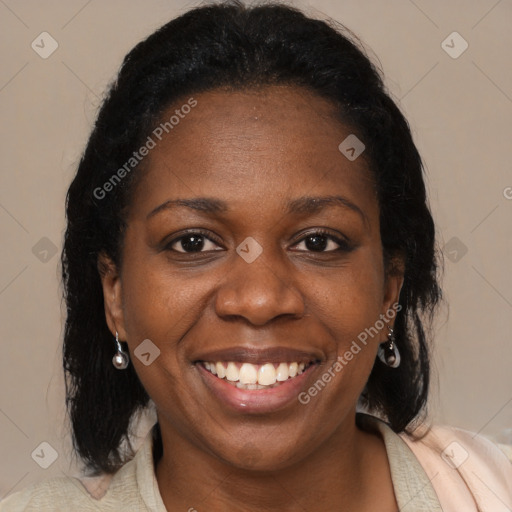 Joyful black adult female with medium  brown hair and brown eyes