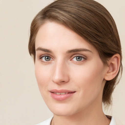 Joyful white young-adult female with medium  brown hair and green eyes