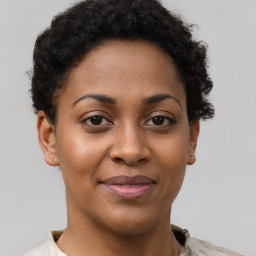 Joyful black young-adult female with short  brown hair and brown eyes