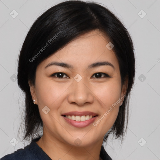 Joyful asian young-adult female with medium  black hair and brown eyes