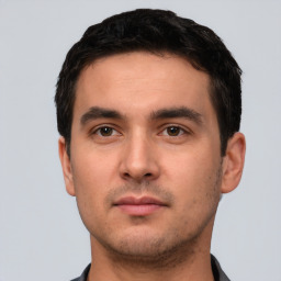 Neutral white young-adult male with short  black hair and brown eyes