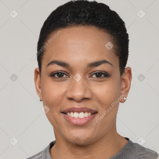 Joyful black young-adult female with short  black hair and brown eyes