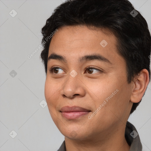 Joyful asian young-adult male with short  black hair and brown eyes