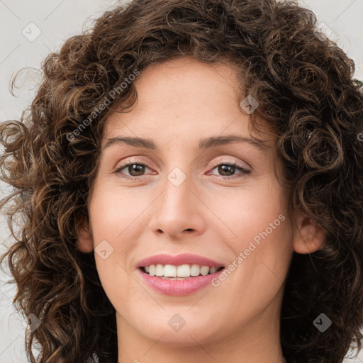 Joyful white young-adult female with medium  brown hair and green eyes