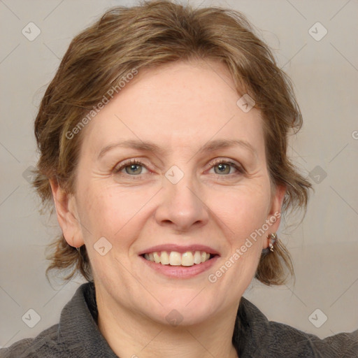 Joyful white adult female with medium  brown hair and blue eyes