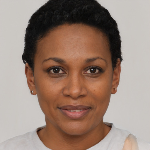 Joyful black adult female with short  black hair and brown eyes