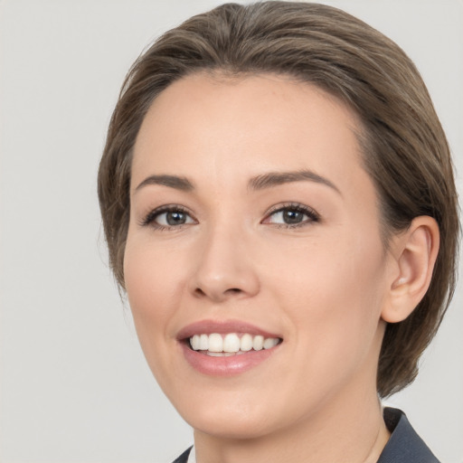 Joyful white young-adult female with medium  brown hair and brown eyes