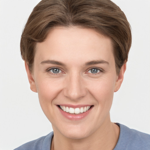 Joyful white young-adult female with short  brown hair and grey eyes