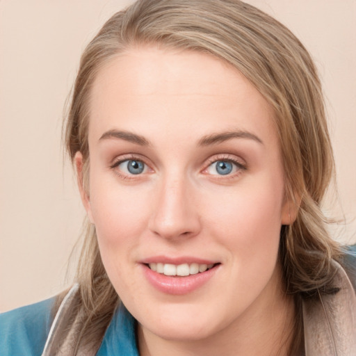 Joyful white young-adult female with medium  brown hair and blue eyes