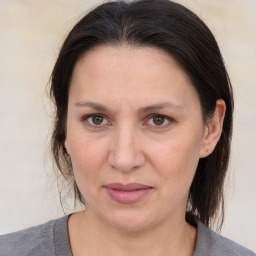 Joyful white adult female with medium  brown hair and brown eyes