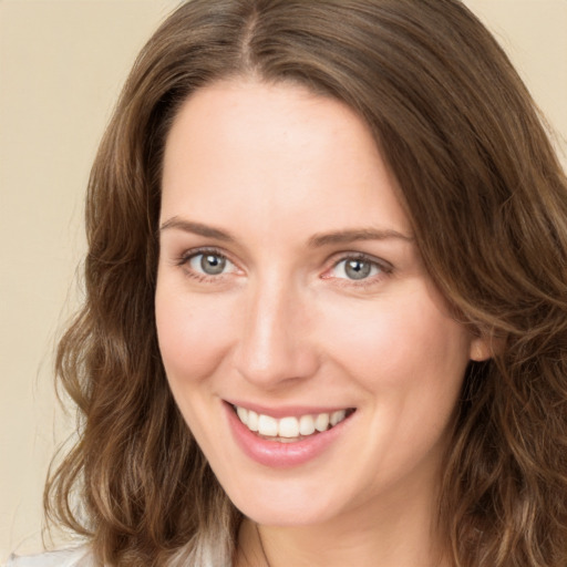 Joyful white young-adult female with medium  brown hair and green eyes