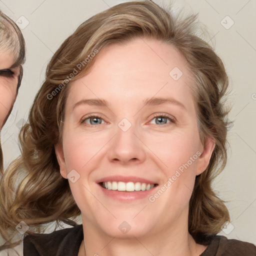 Joyful white adult female with medium  brown hair and blue eyes