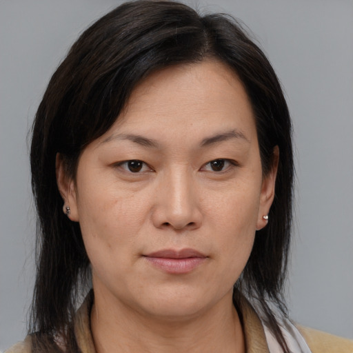 Joyful asian adult female with medium  brown hair and brown eyes