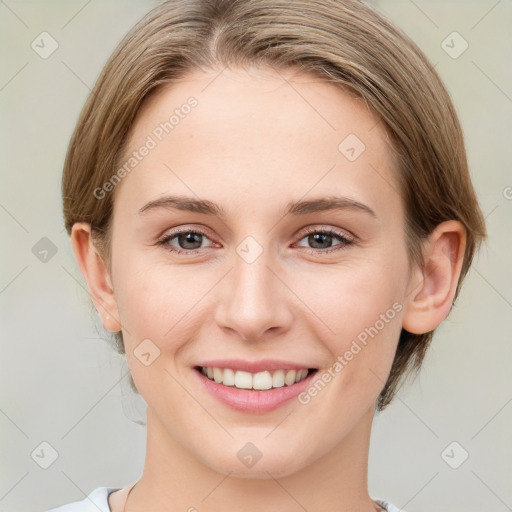 Joyful white young-adult female with medium  brown hair and grey eyes