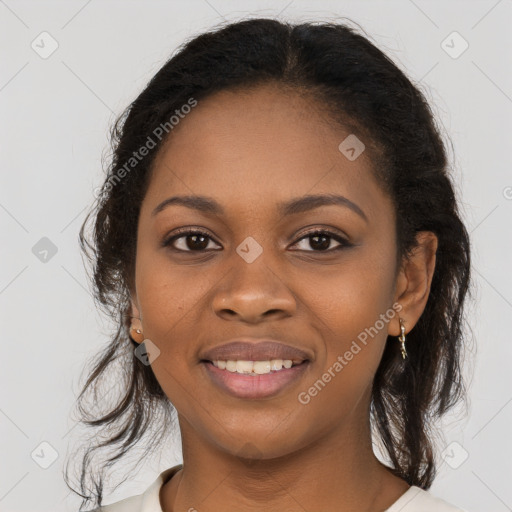 Joyful black young-adult female with long  brown hair and brown eyes