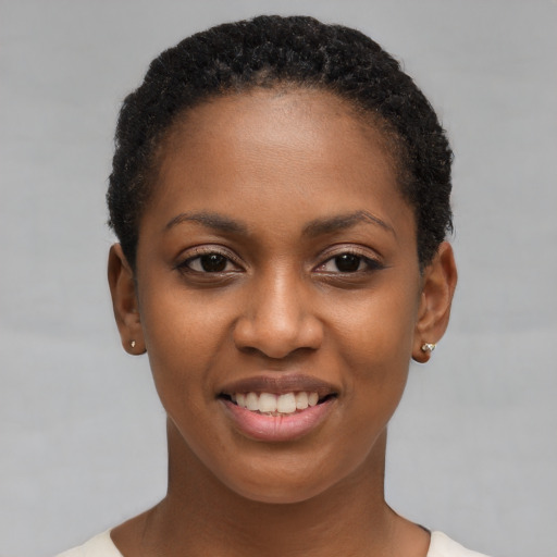 Joyful black young-adult female with short  brown hair and brown eyes