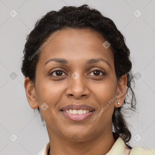 Joyful black adult female with short  brown hair and brown eyes