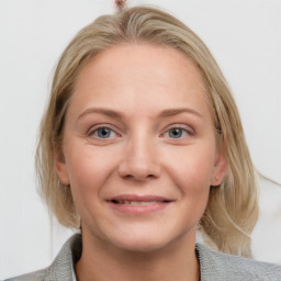 Joyful white young-adult female with medium  brown hair and blue eyes