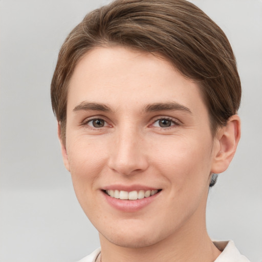 Joyful white young-adult female with short  brown hair and grey eyes