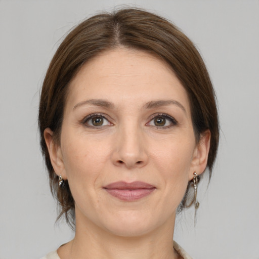 Joyful white adult female with medium  brown hair and brown eyes