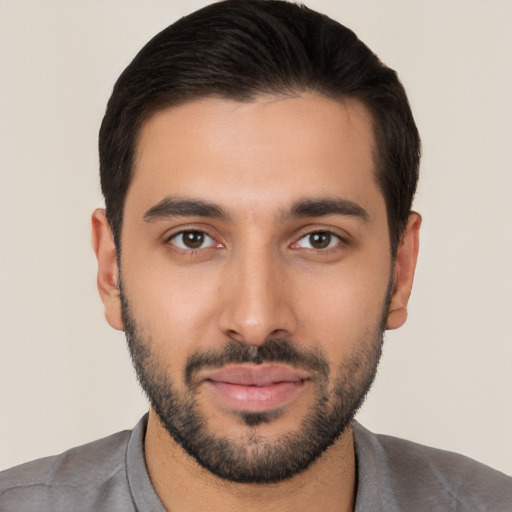 Joyful white young-adult male with short  black hair and brown eyes