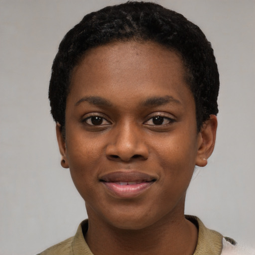 Joyful black young-adult female with short  black hair and brown eyes