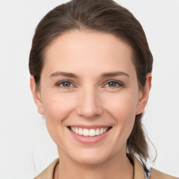 Joyful white young-adult female with medium  brown hair and grey eyes