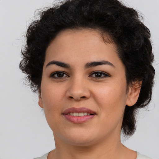 Joyful latino young-adult female with short  brown hair and brown eyes