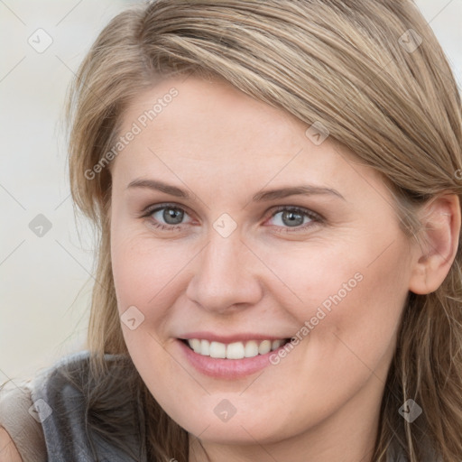 Joyful white young-adult female with long  brown hair and blue eyes