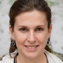 Joyful white adult female with medium  brown hair and brown eyes