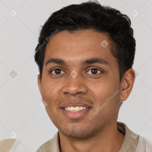 Joyful black young-adult male with short  black hair and brown eyes