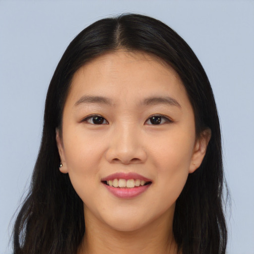 Joyful asian young-adult female with long  brown hair and brown eyes