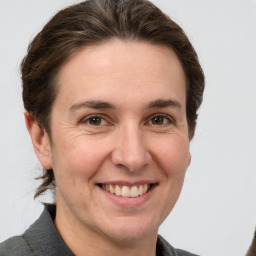 Joyful white adult female with short  brown hair and grey eyes