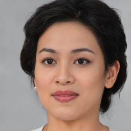 Joyful asian young-adult female with medium  brown hair and brown eyes