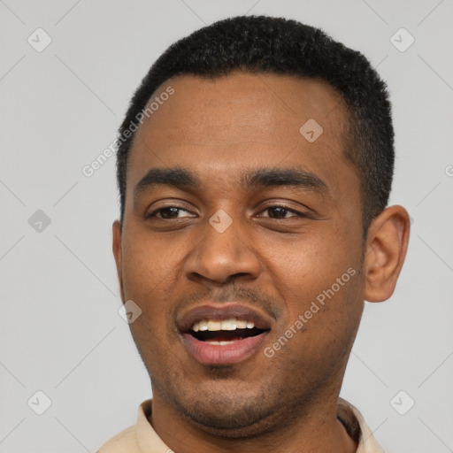 Joyful black young-adult male with short  black hair and brown eyes