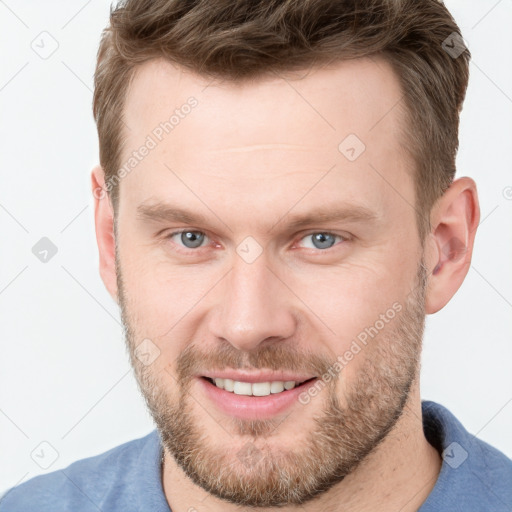 Joyful white adult male with short  brown hair and grey eyes