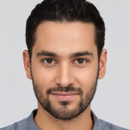 Joyful white young-adult male with short  black hair and brown eyes