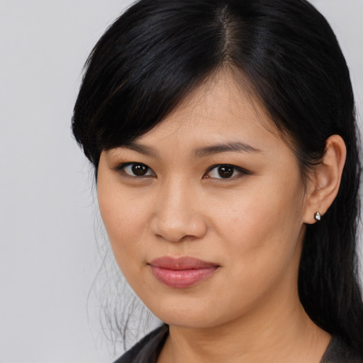 Joyful asian young-adult female with long  black hair and brown eyes