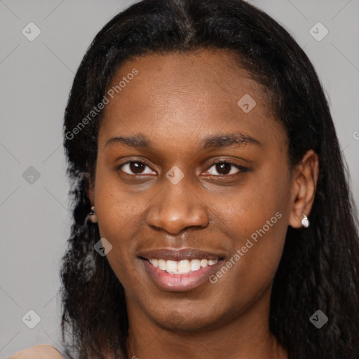 Joyful black young-adult female with long  black hair and brown eyes