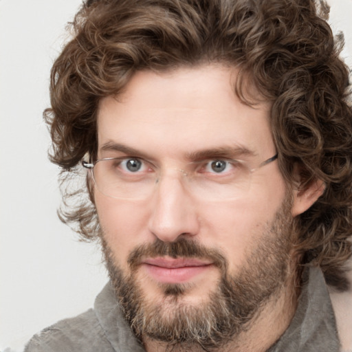 Joyful white adult male with short  brown hair and green eyes