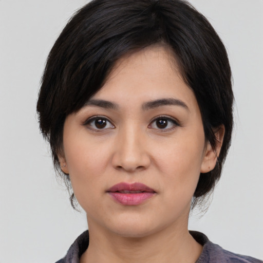 Joyful asian young-adult female with medium  black hair and brown eyes