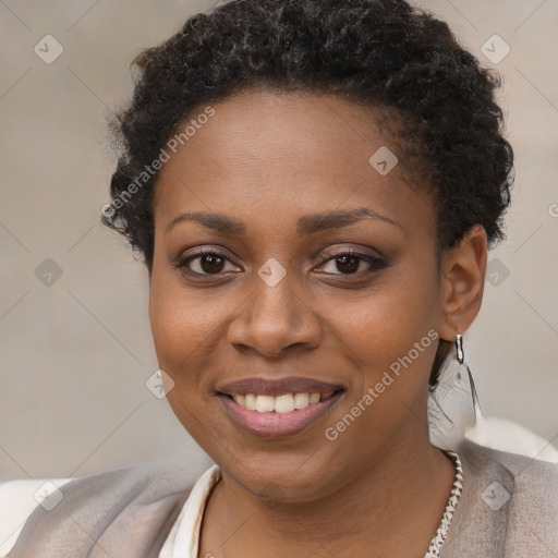 Joyful black young-adult female with short  brown hair and brown eyes