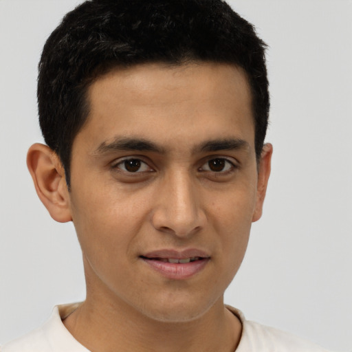 Joyful latino young-adult male with short  brown hair and brown eyes