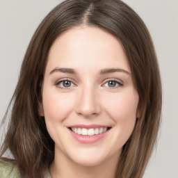 Joyful white young-adult female with medium  brown hair and green eyes