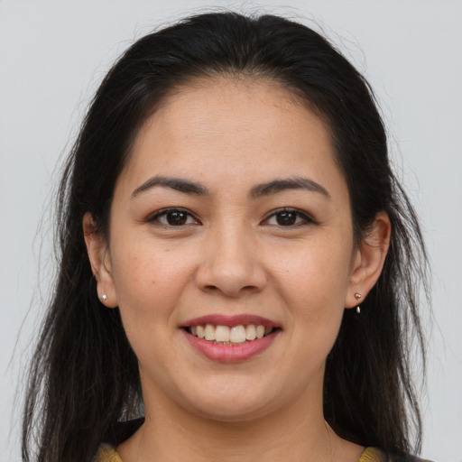 Joyful asian young-adult female with long  brown hair and brown eyes