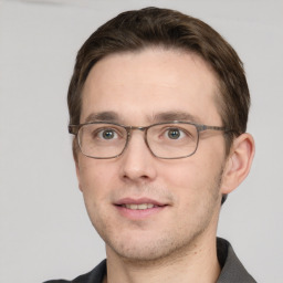 Joyful white adult male with short  brown hair and grey eyes